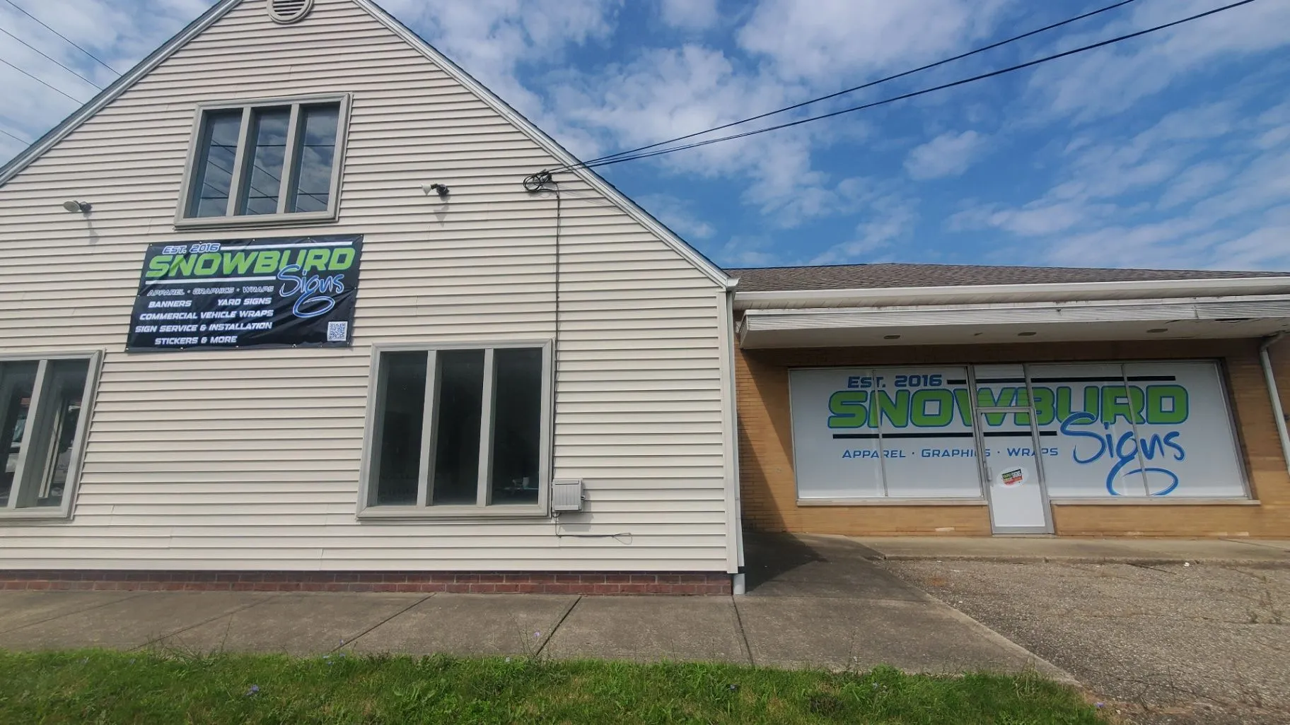 Snowburd Signs storefront with perforated window graphics